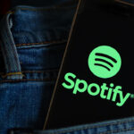 In this photo illustration, a Spotify music app logo seen